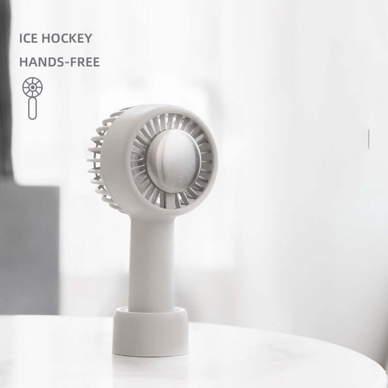 Portable USB-powered electric hockey fan in Haoyue white, showcased on a table, ideal for hands-free cooling.