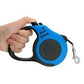 Hand holding a blue pet automatic telescopic traction rope with one-touch control system.