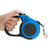 Hand holding a blue pet automatic telescopic traction rope with one-touch control system.