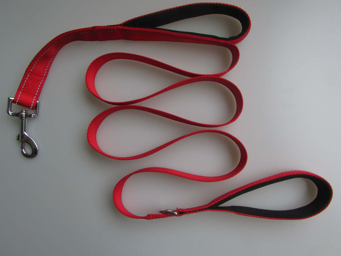 Red double handle pull leash with reflective strip and metal buckle for pet walking.