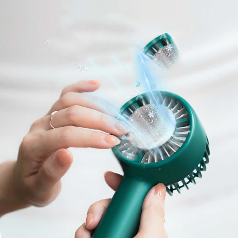 User adjusting a PiKa PiKa portable USB hockey fan in Cong Lin green color with cooling airflow effect.
