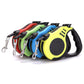 Colorful pet automatic telescopic traction ropes in red, green, blue, and yellow for small dogs.