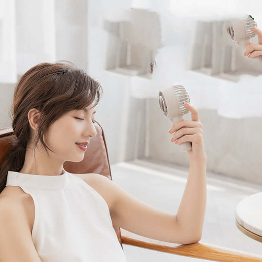 Woman relaxing with PiKa PiKa Portable hockey fan in light lotus gray and powered by USB.